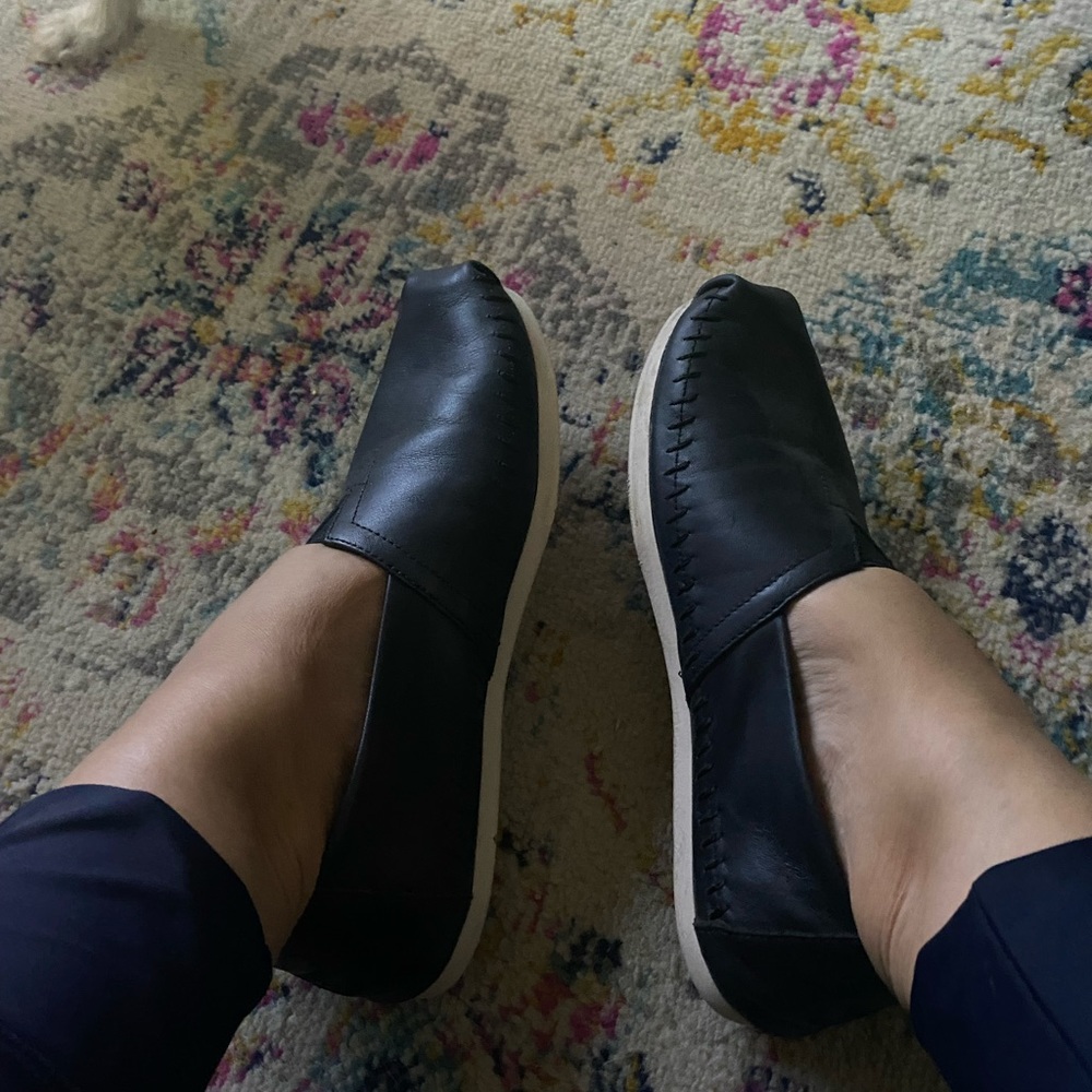 Size 10 Toms slip ons. Leather upper. Black. Super comfortable.